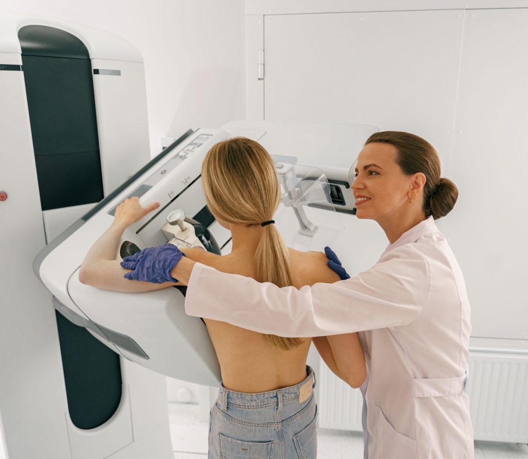 Professional radiologist doing mammogram x ray for young woman to check for breast cancer